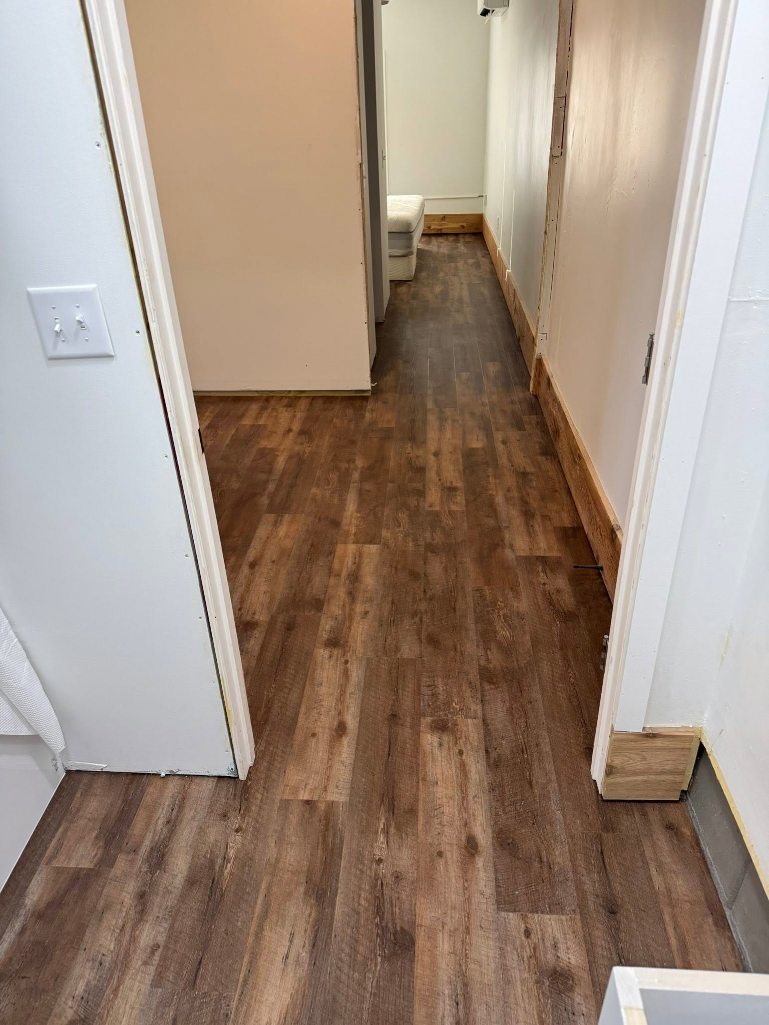 Rustic dark wood-look luxury vinyl plank in a home hallway