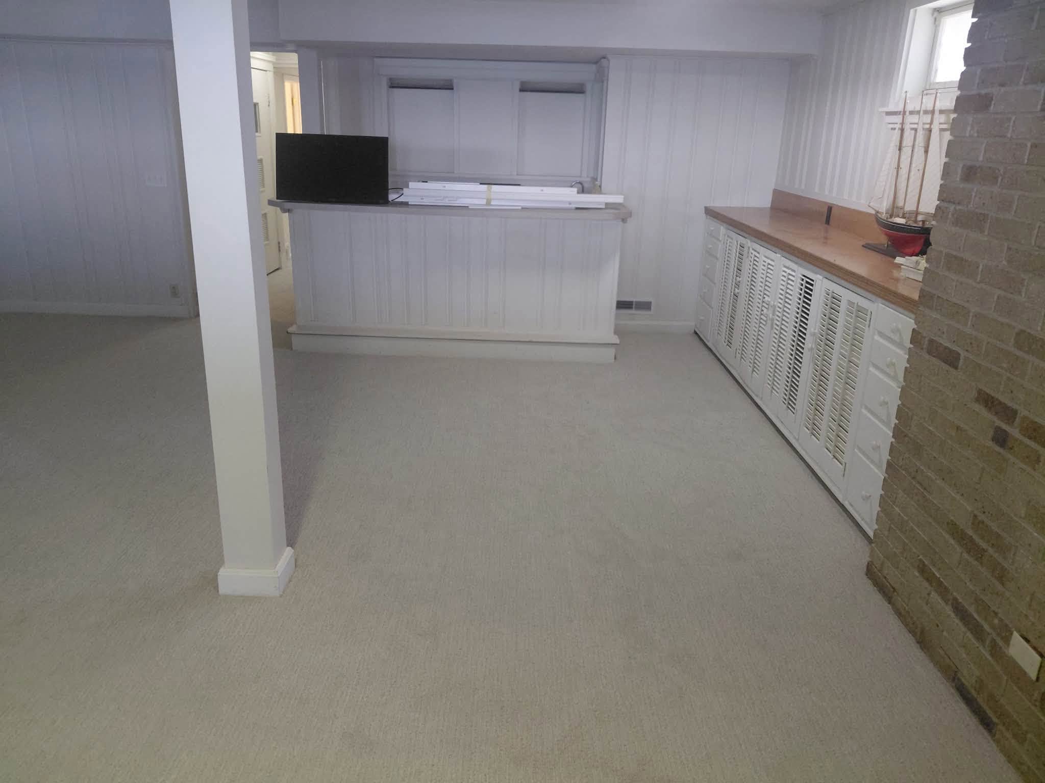 Fresh neutral carpet in a finished basement