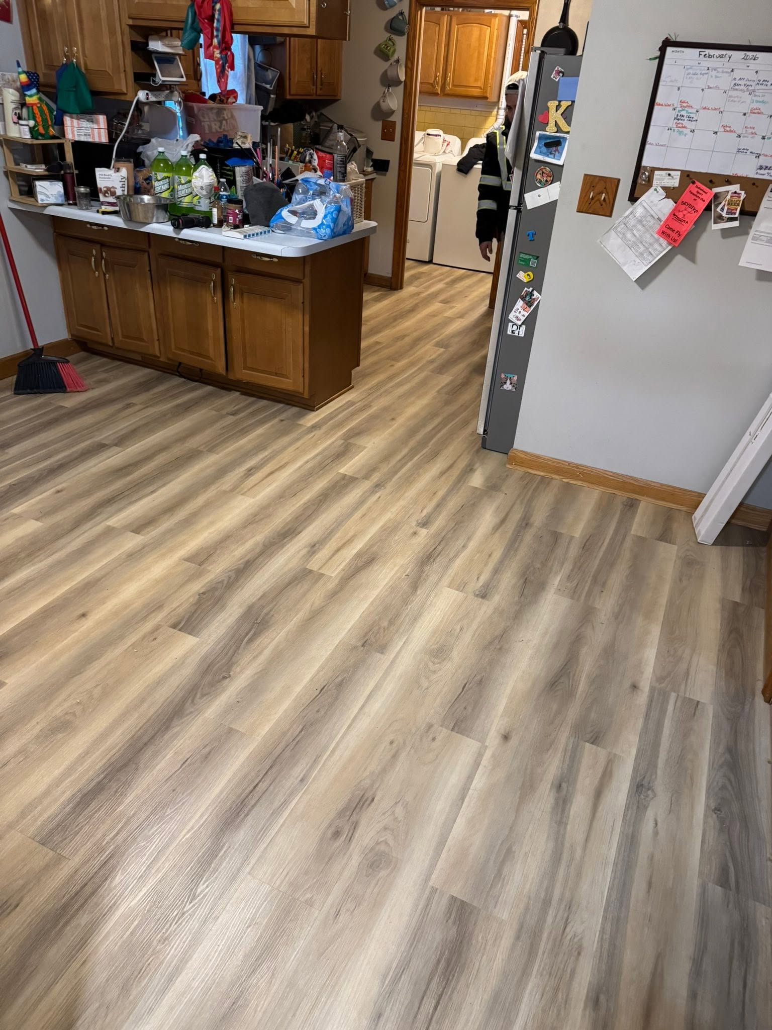 Light oak luxury vinyl plank flooring installed in a kitchen