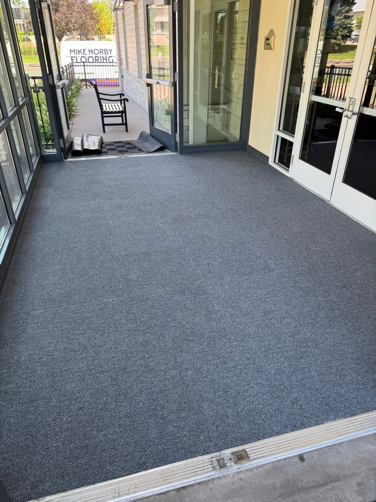 Durable commercial entryway carpet in an apartment building vestibule